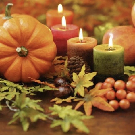 Thanksgiving 2020 pumpkin, lit candles, maple leafs